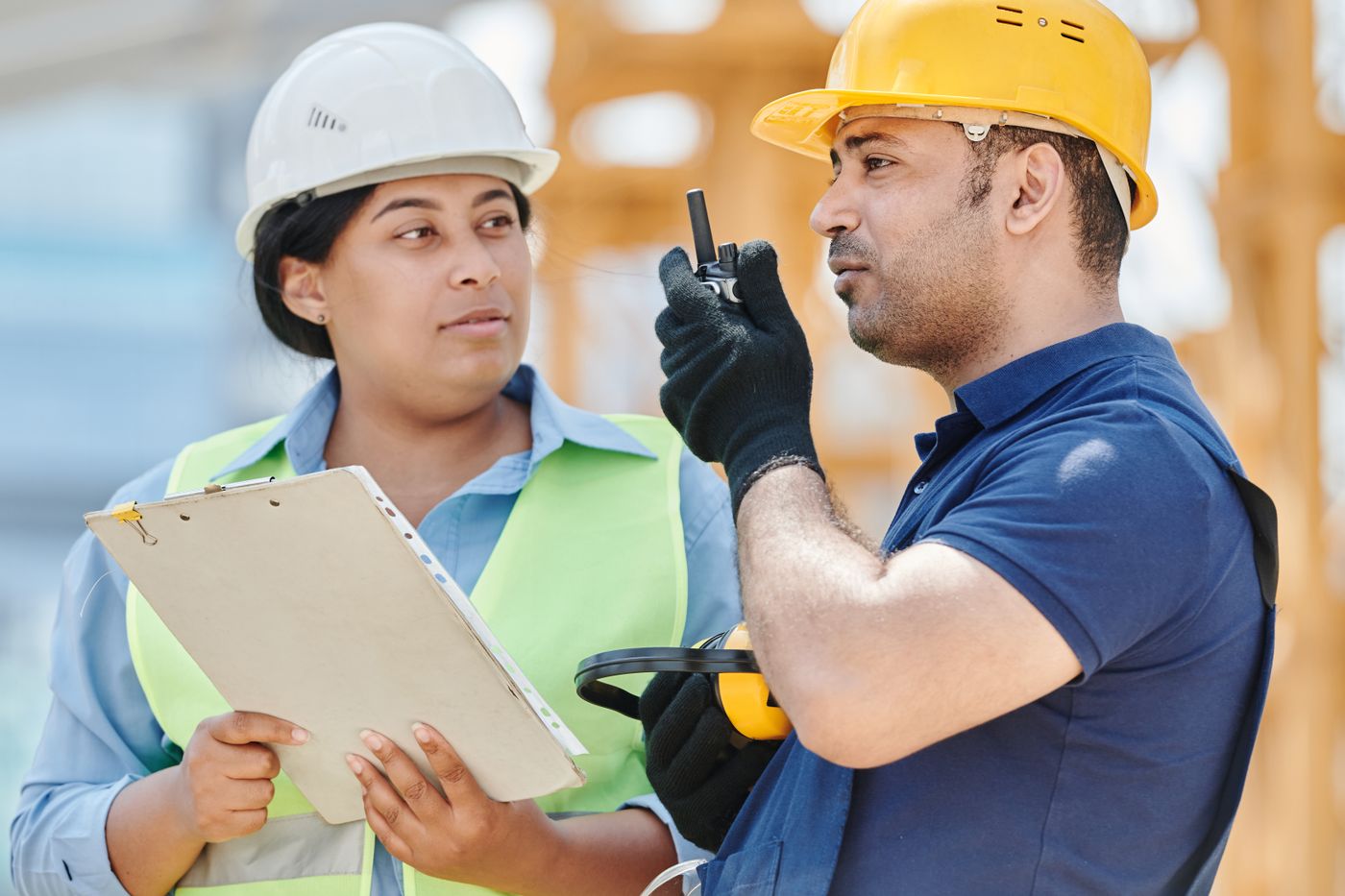 Construction professionals coordinating plans at a job site